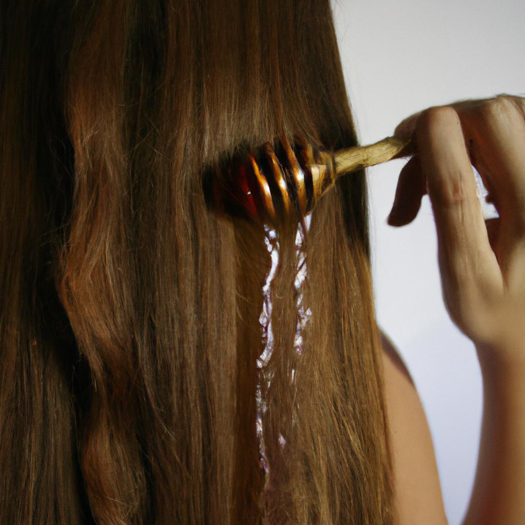 Person applying honey to hair
